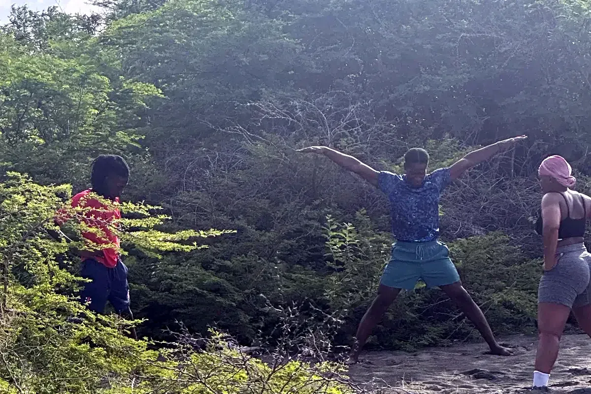 Yoga Angels guests stretching on a nature hike near the salt pond in Yallahs, St. Thomas