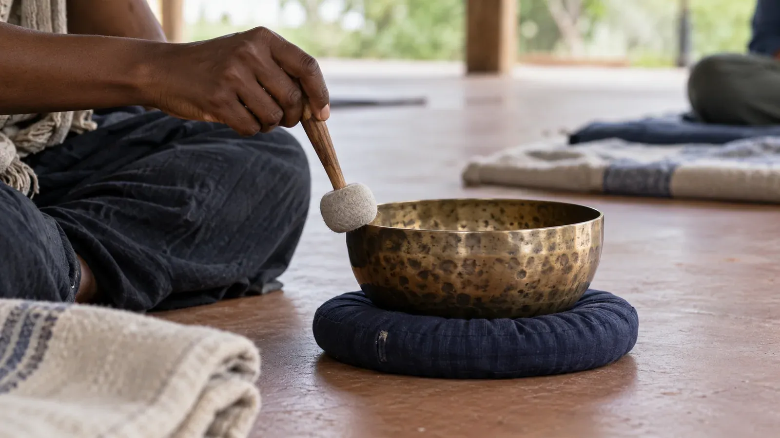 AI-generated illustration: a facilitator using a bronze singing bowl during a quiet listening session